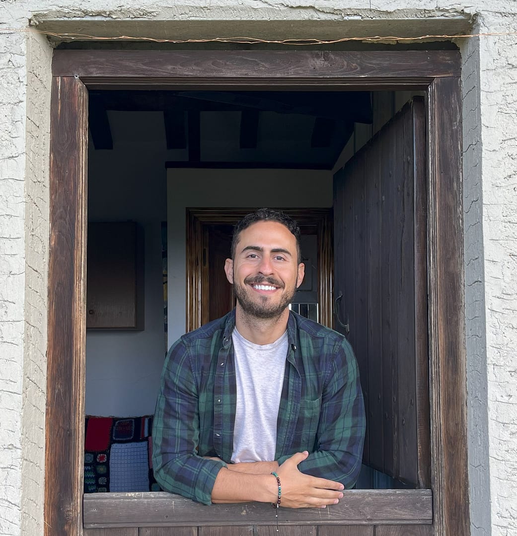 Headshot of Stephen Fagen from the waist up smiling and looking out of a doorway